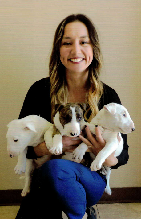 Image of Dr. Hoang with three puppies